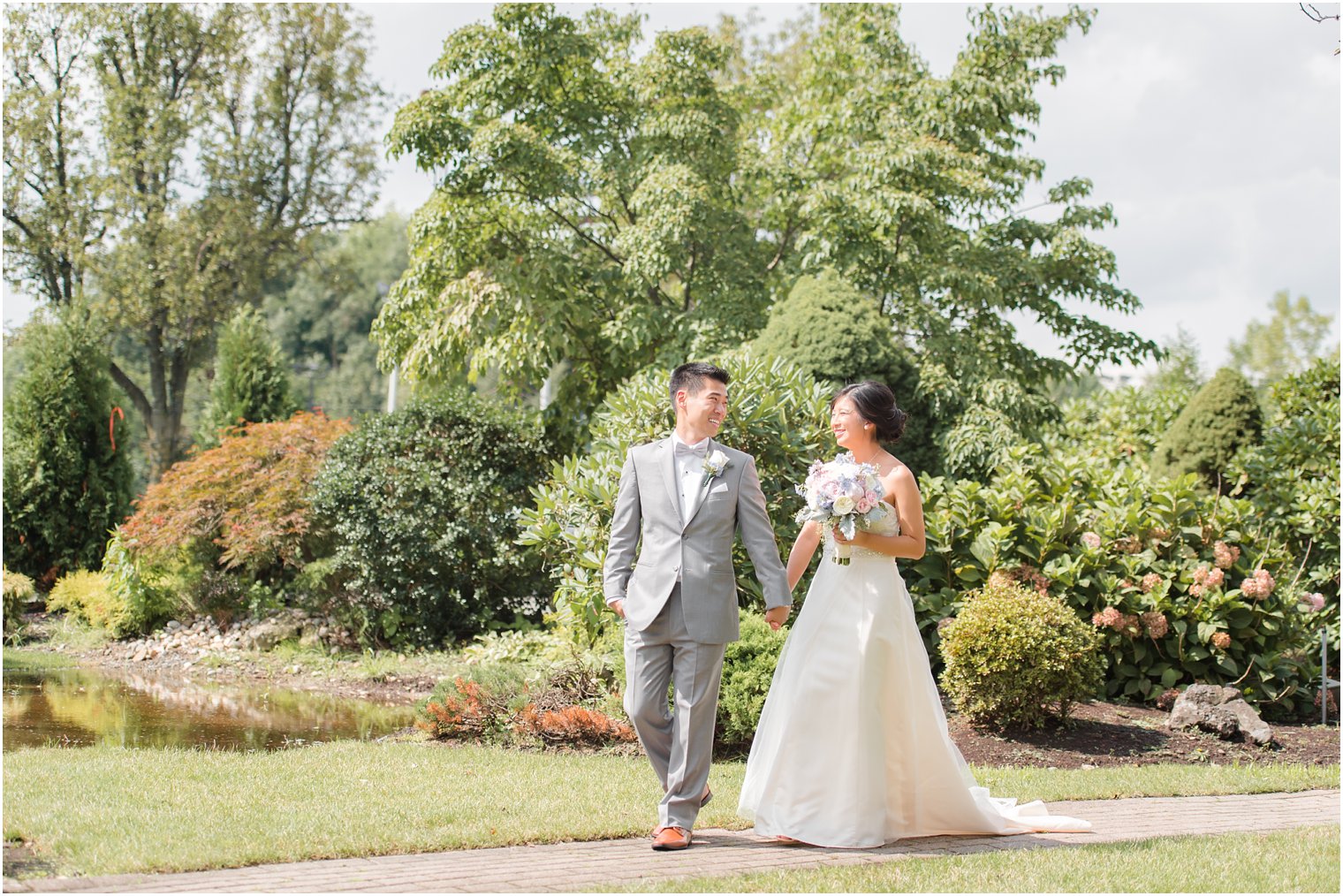 bride and groom walk through garden at The Bethwood