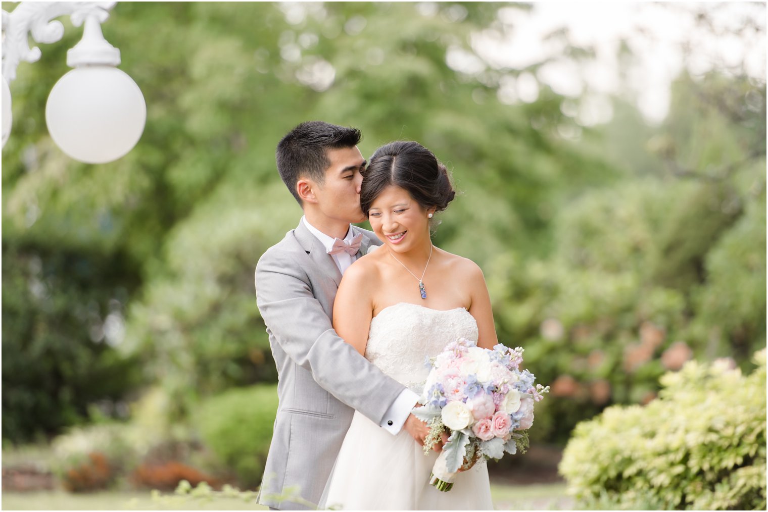 bride and groom snuggle during wedding portraits with Idalia Photography