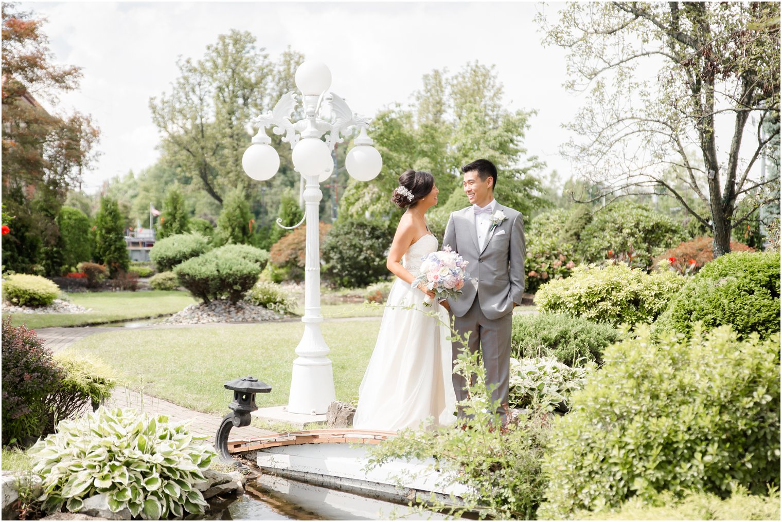 bride and groom smile at each other in gardens at The Bethwood