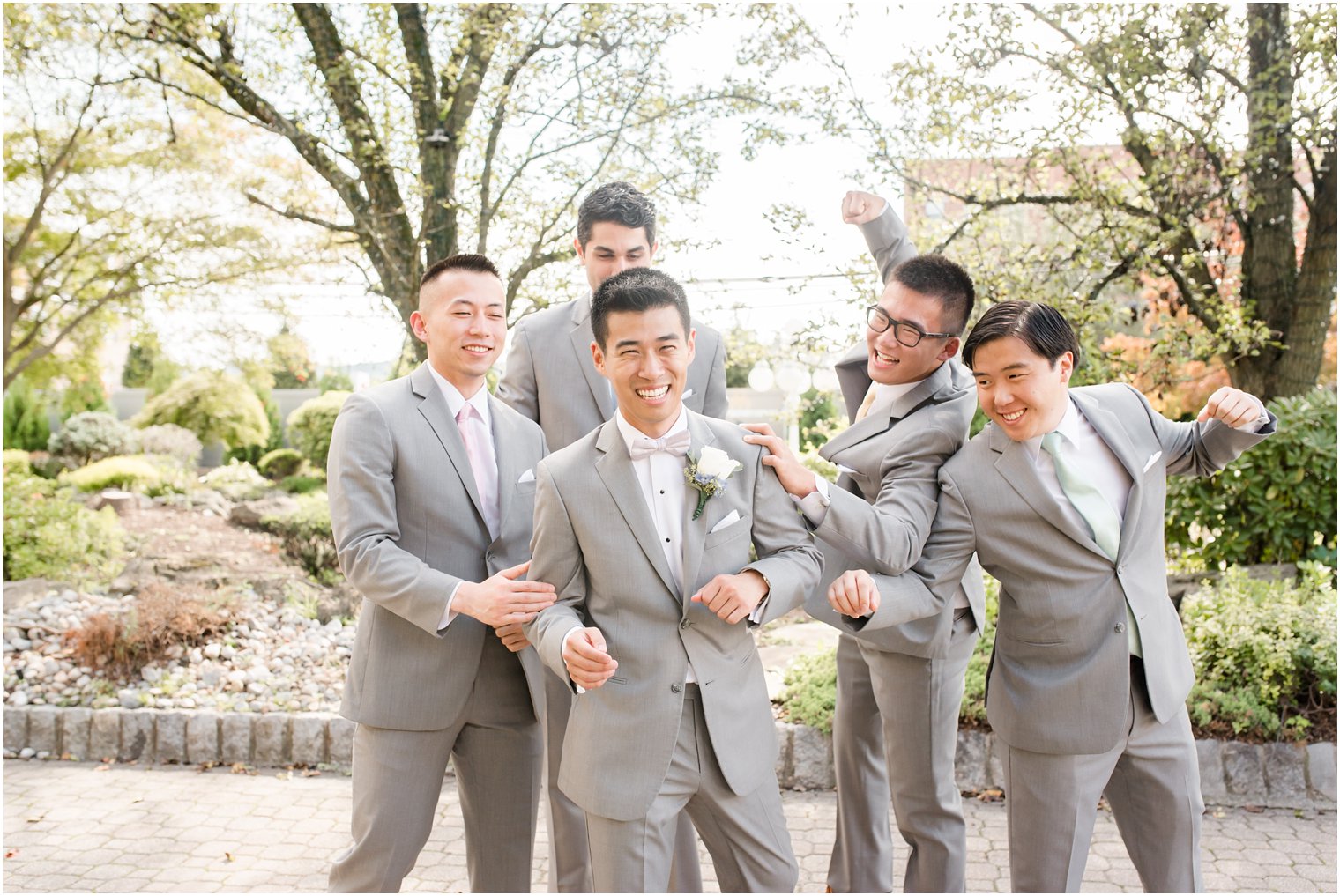 groom goofs off with groomsmen before wedding at The Bethwood