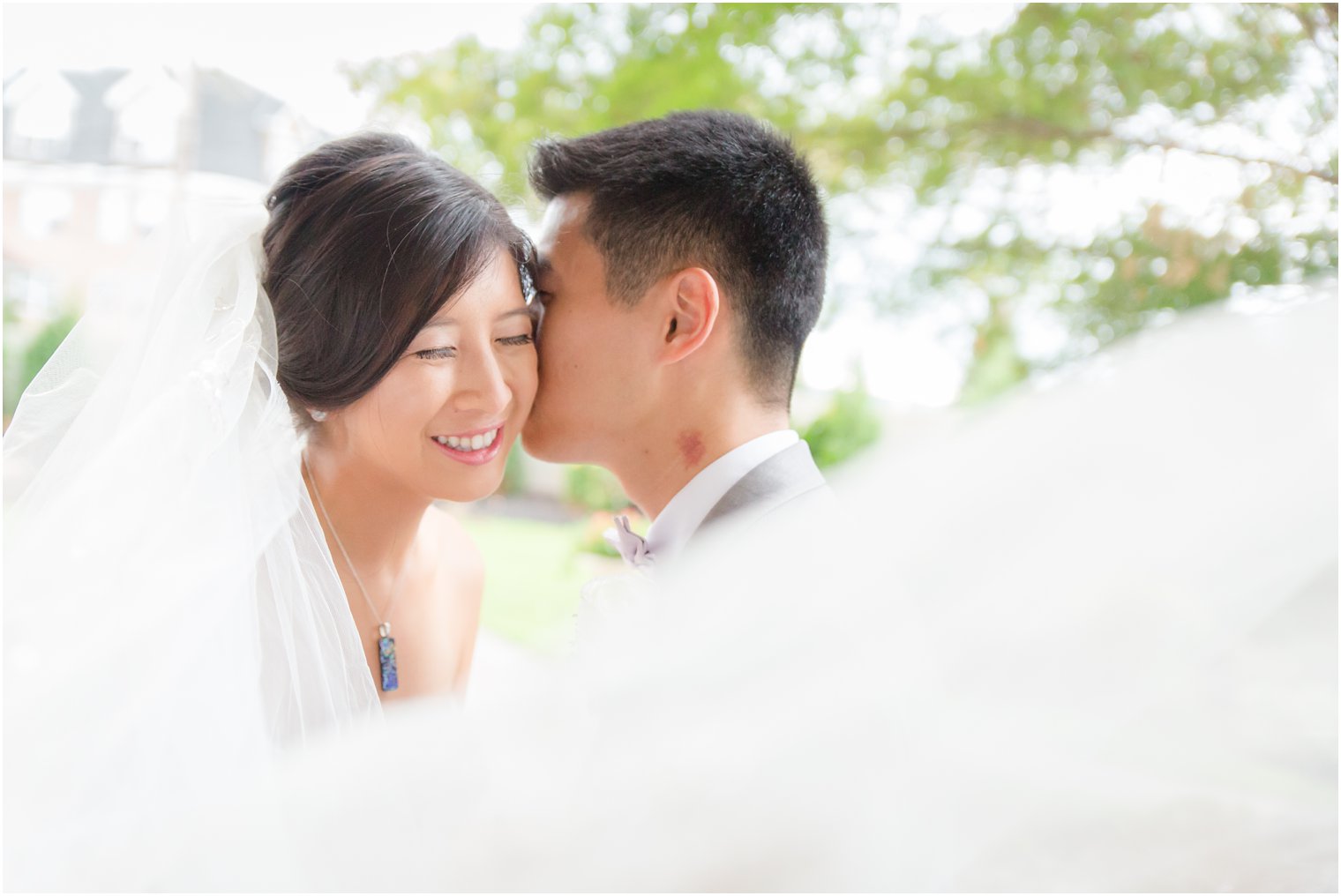 bride and groom portrait with wedding veil by Idalia Photography