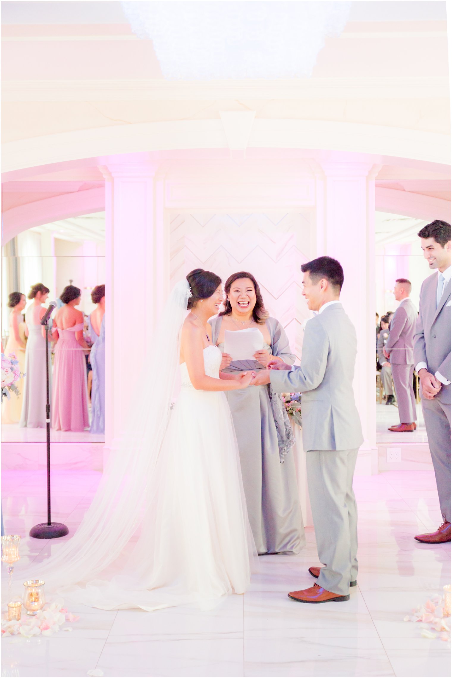 bride and groom exchange rings during wedding ceremony photographed by Idalia Photography