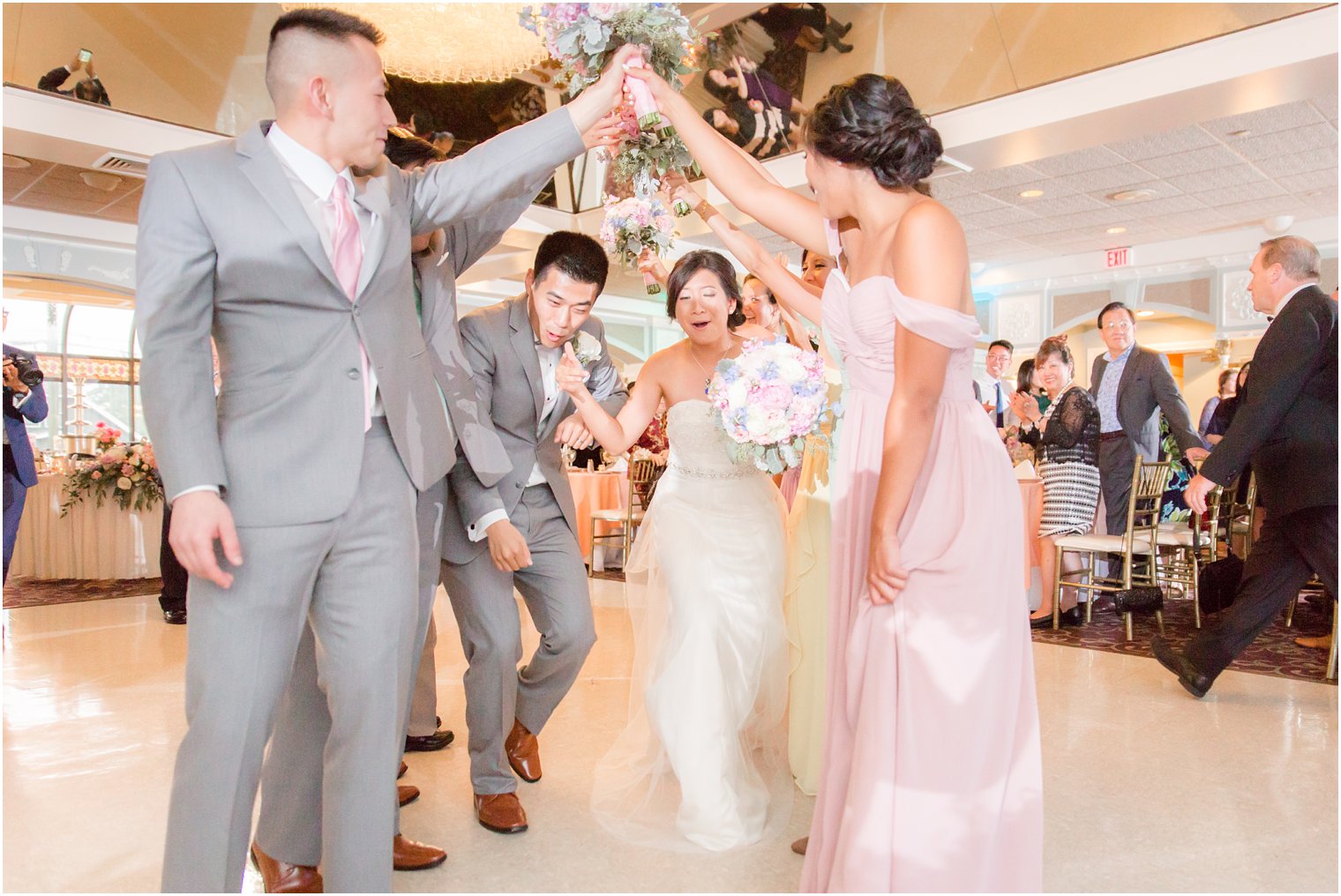 bride and groom enter reception at The Bethwood with wedding party