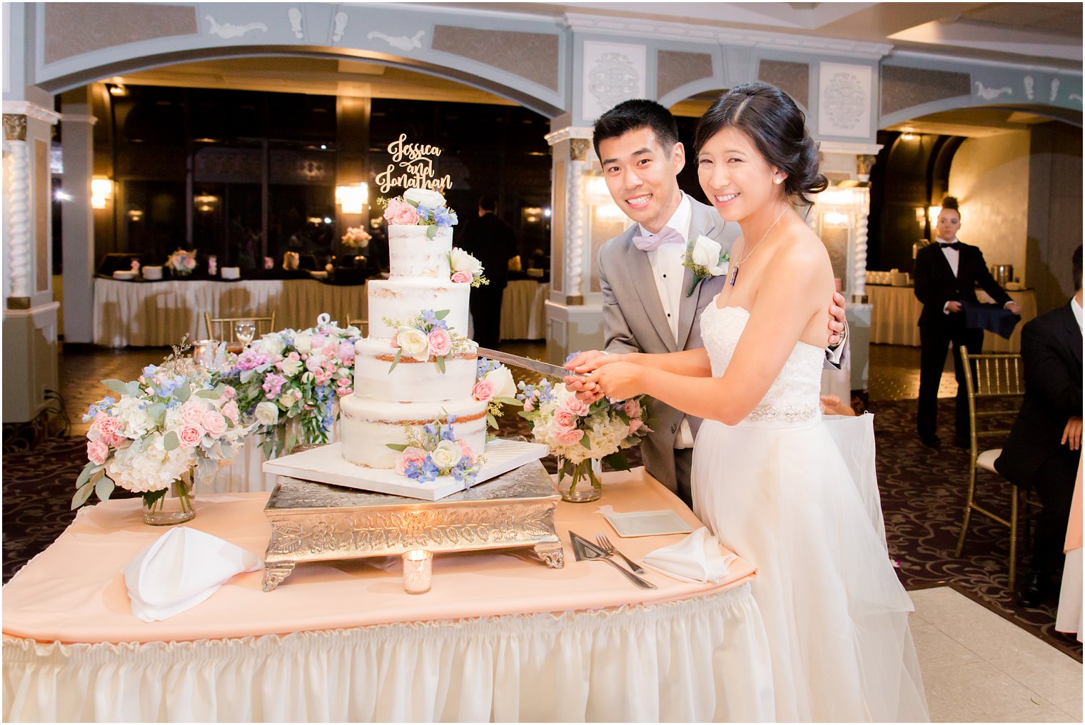 bride and groom cut cake during reception at The Bethwood
