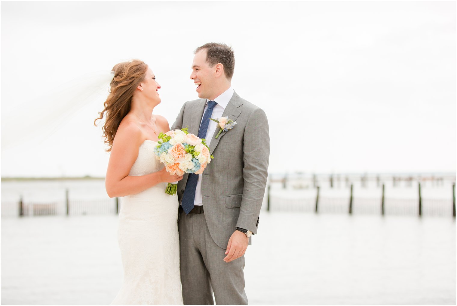 bride and groom laugh during wedding portraits by Idalia Photography