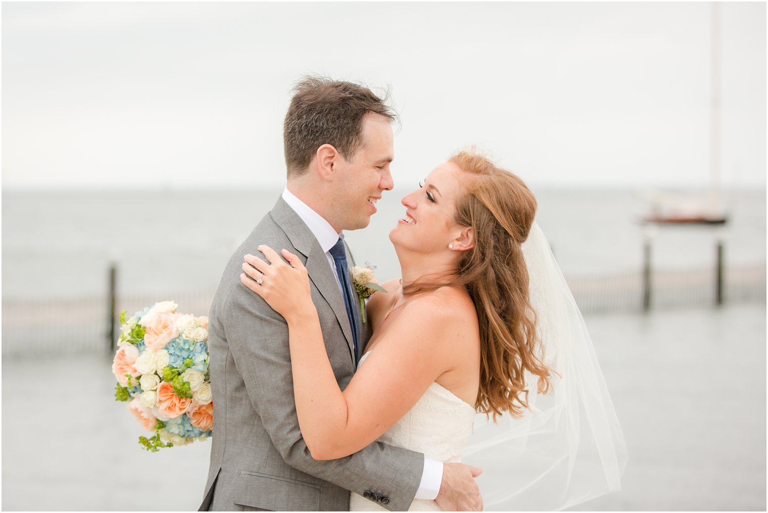 bride and groom on Brant Beach Yacht Club wedding day with Idalia Photography
