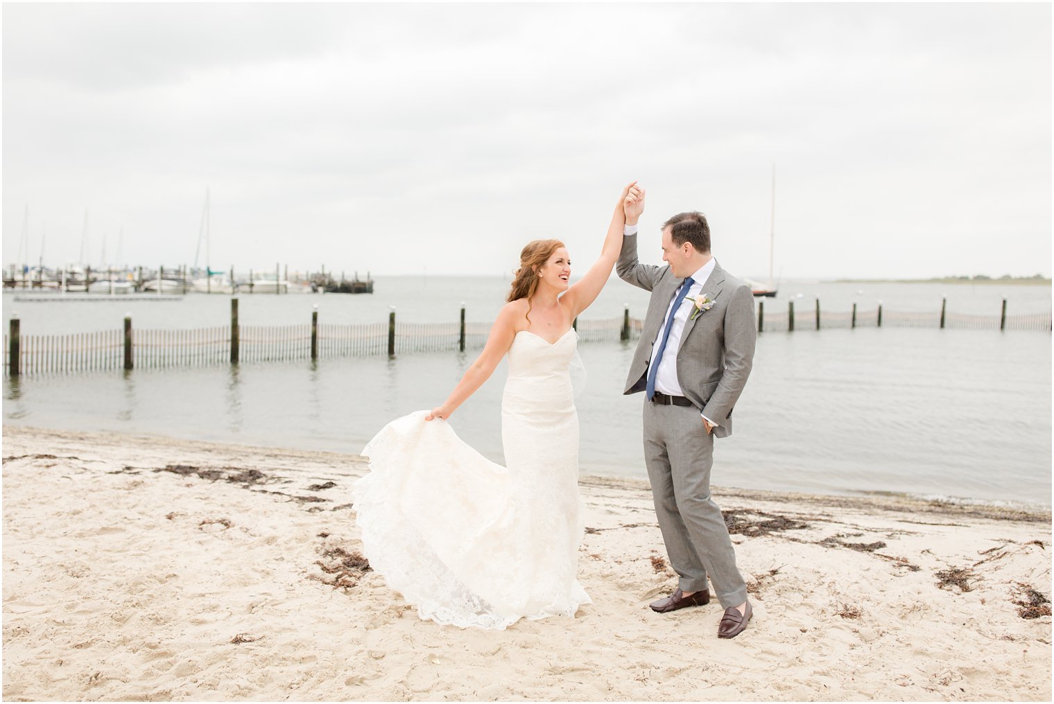 bride and groom dance on the beach during portraits with Idalia Photography
