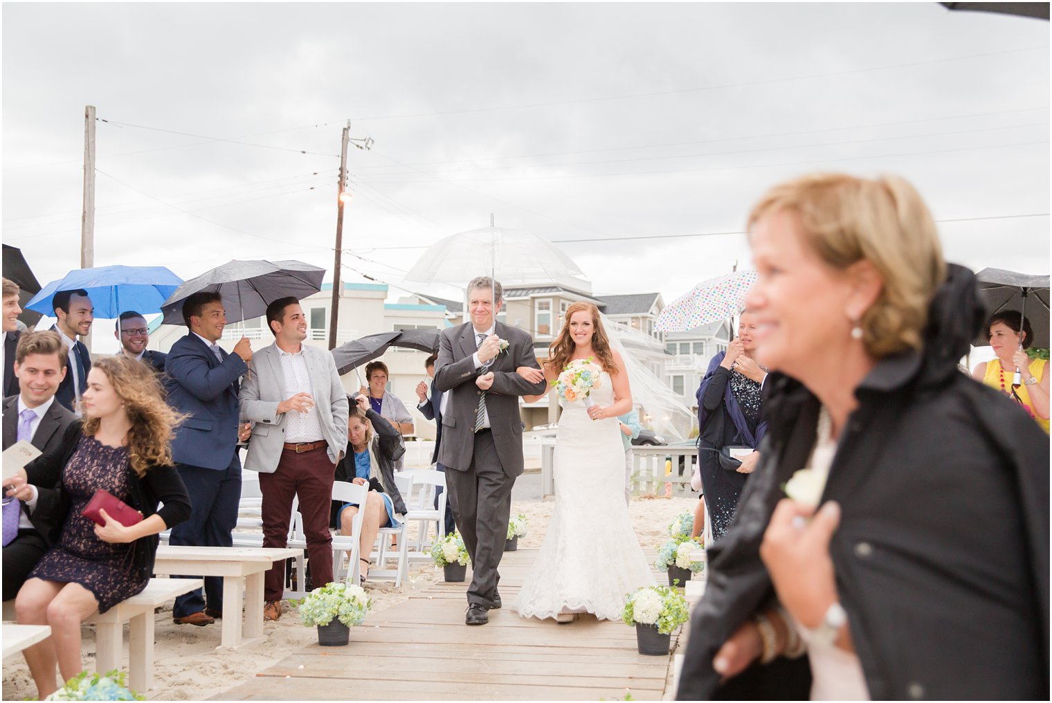 father and bride walk down aisle for oceanfront wedding day at Brant Beach Yacht Club photographed by Idalia Photography
