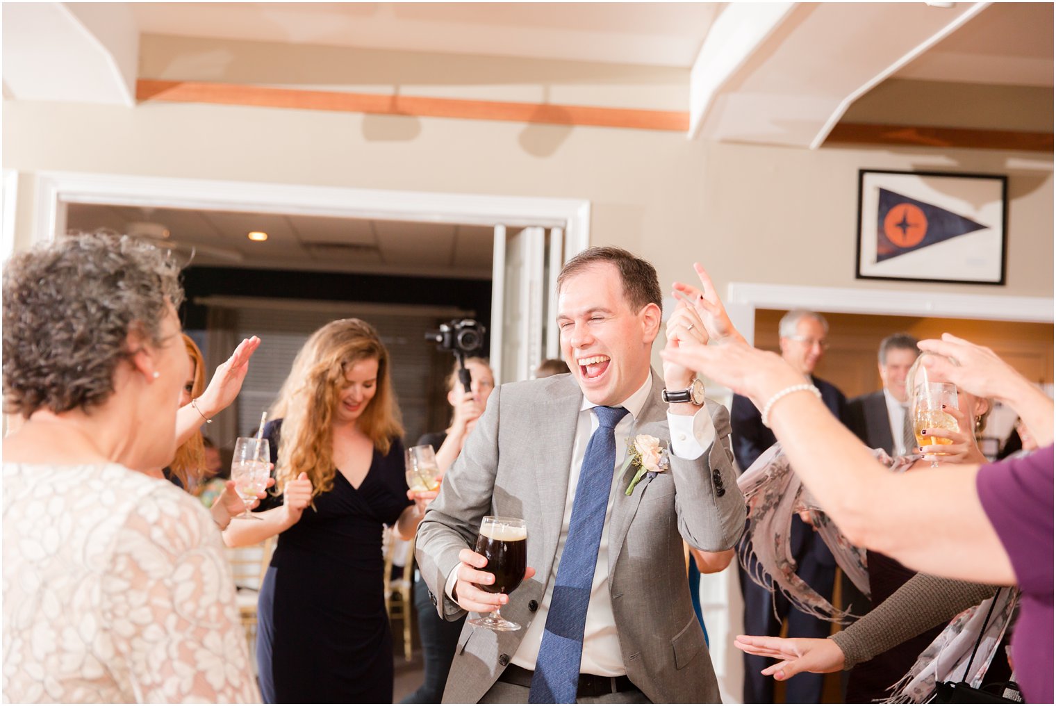 groom dances during reception at Brant Beach Yacht Club photographed by Idalia Photography