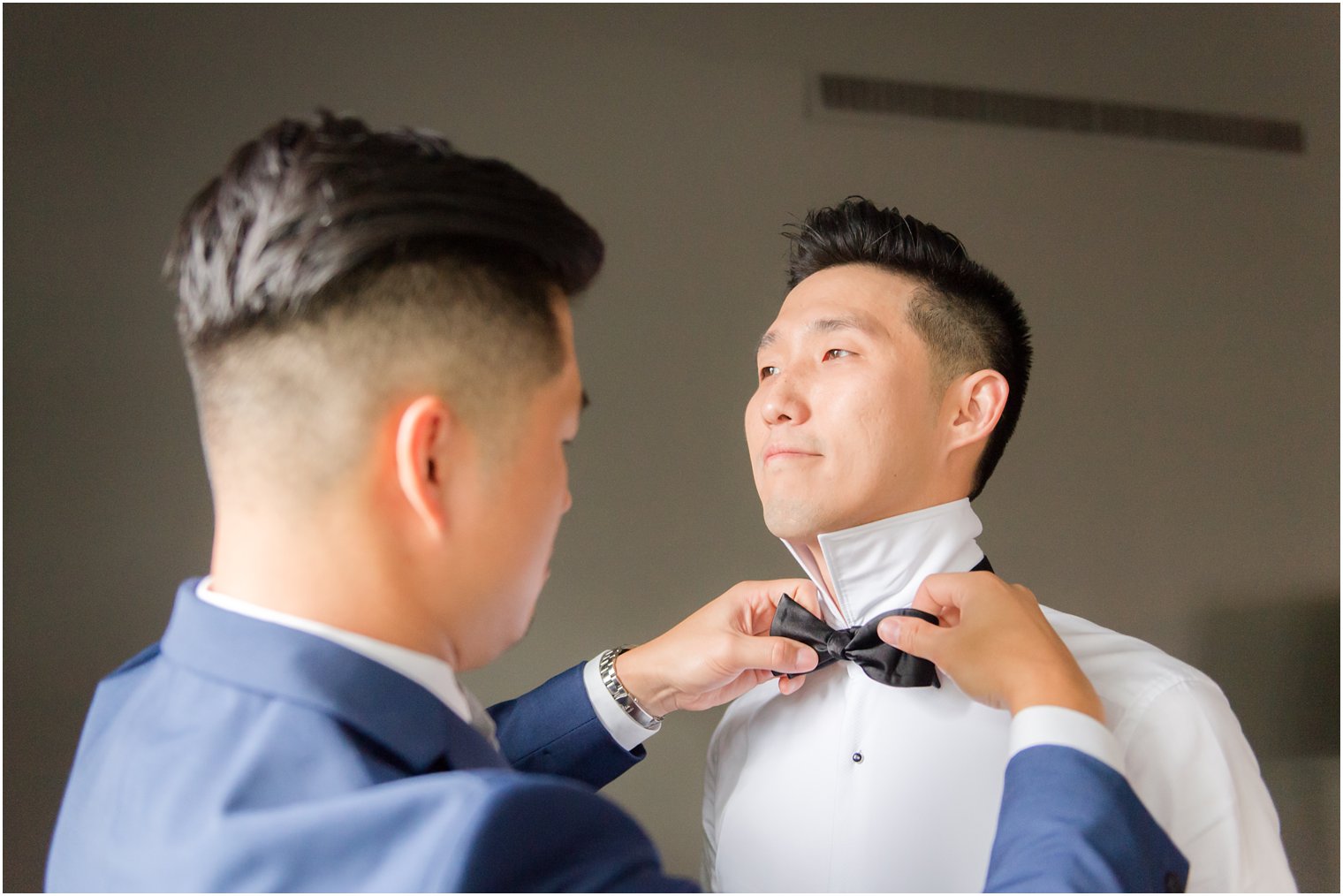 Groom prepares for Princeton NJ wedding day with groomsman photographed by Idalia Photography