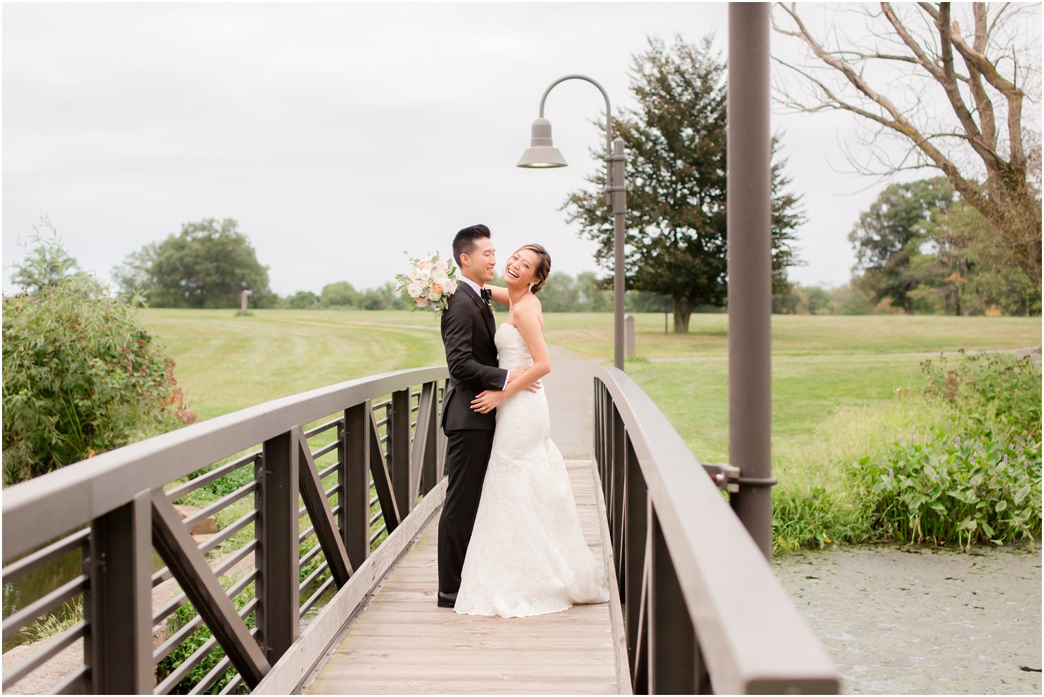 happy couple on bridge at Chauncey Hotel photographed by Idalia Photography