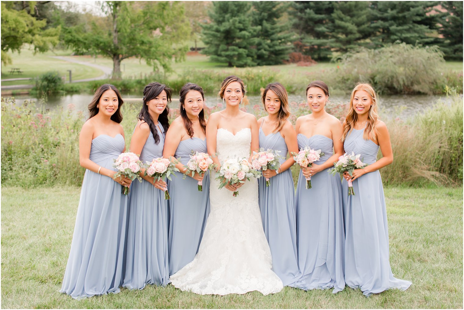 bride with bridesmaids in dusty blue gowns for Chauncey Hotel wedding day