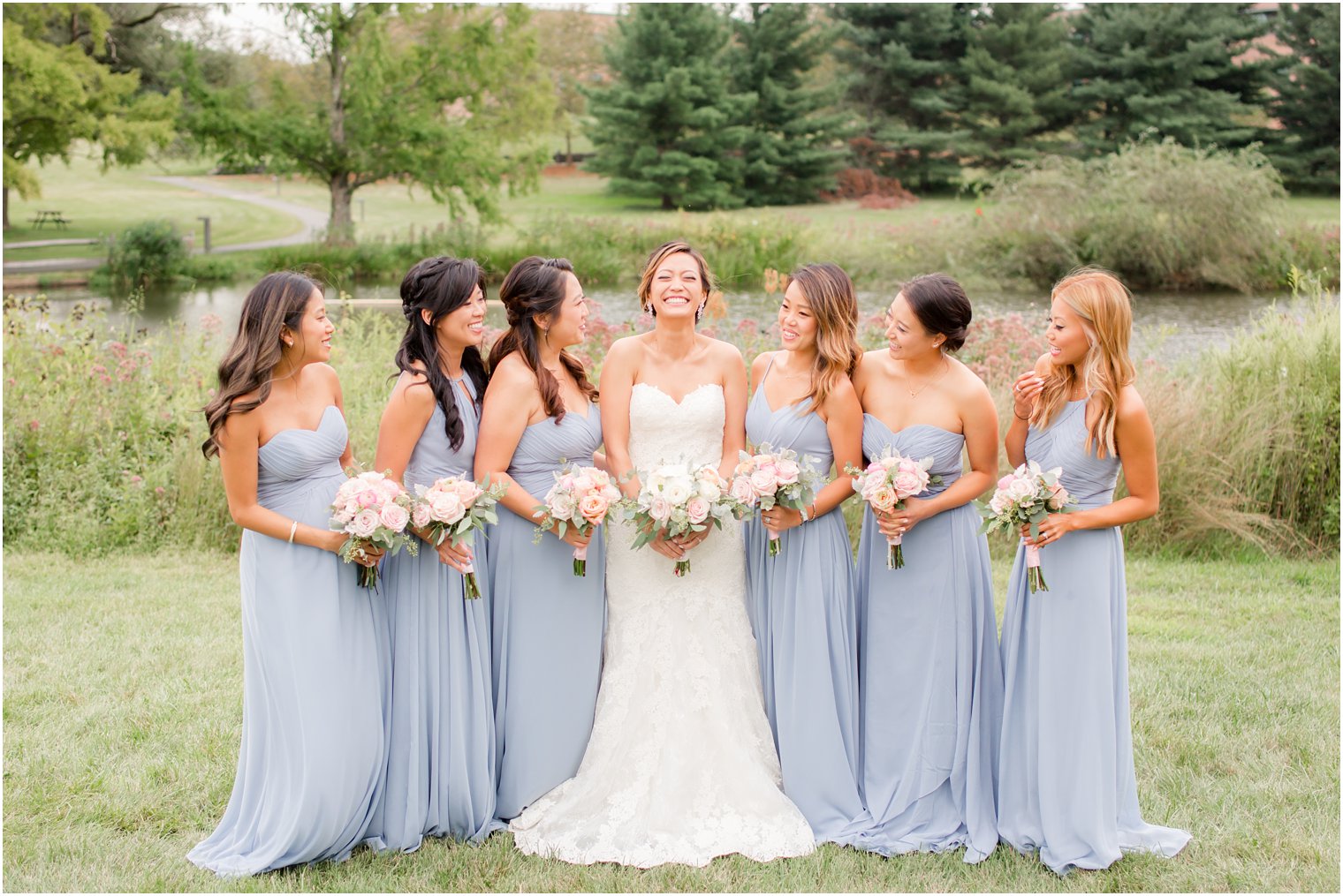 bride and bridesmaids hold light pink bouquets by Peonia
