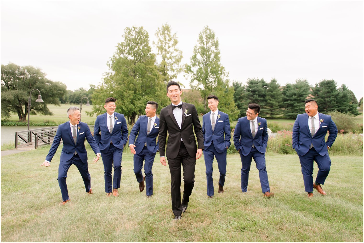 groomsmen laughing during portraits at Chauncey Hotel photographed by Idalia Photography