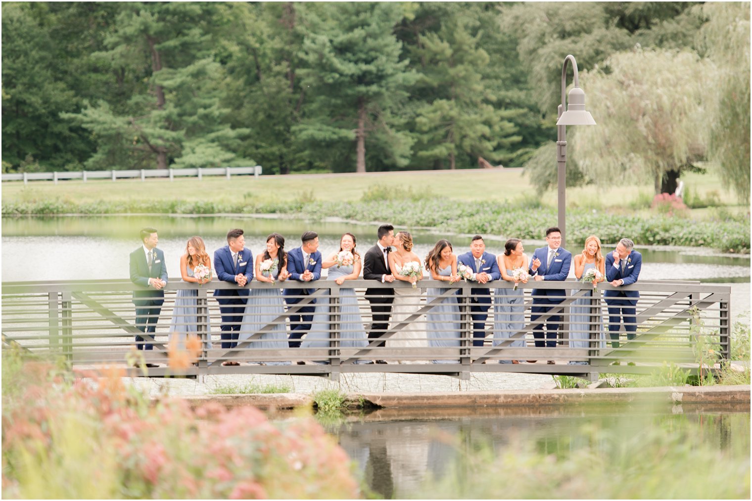 wedding party on bridge at Chauncey Hotel in New Jersey photographed by Idalia Photography