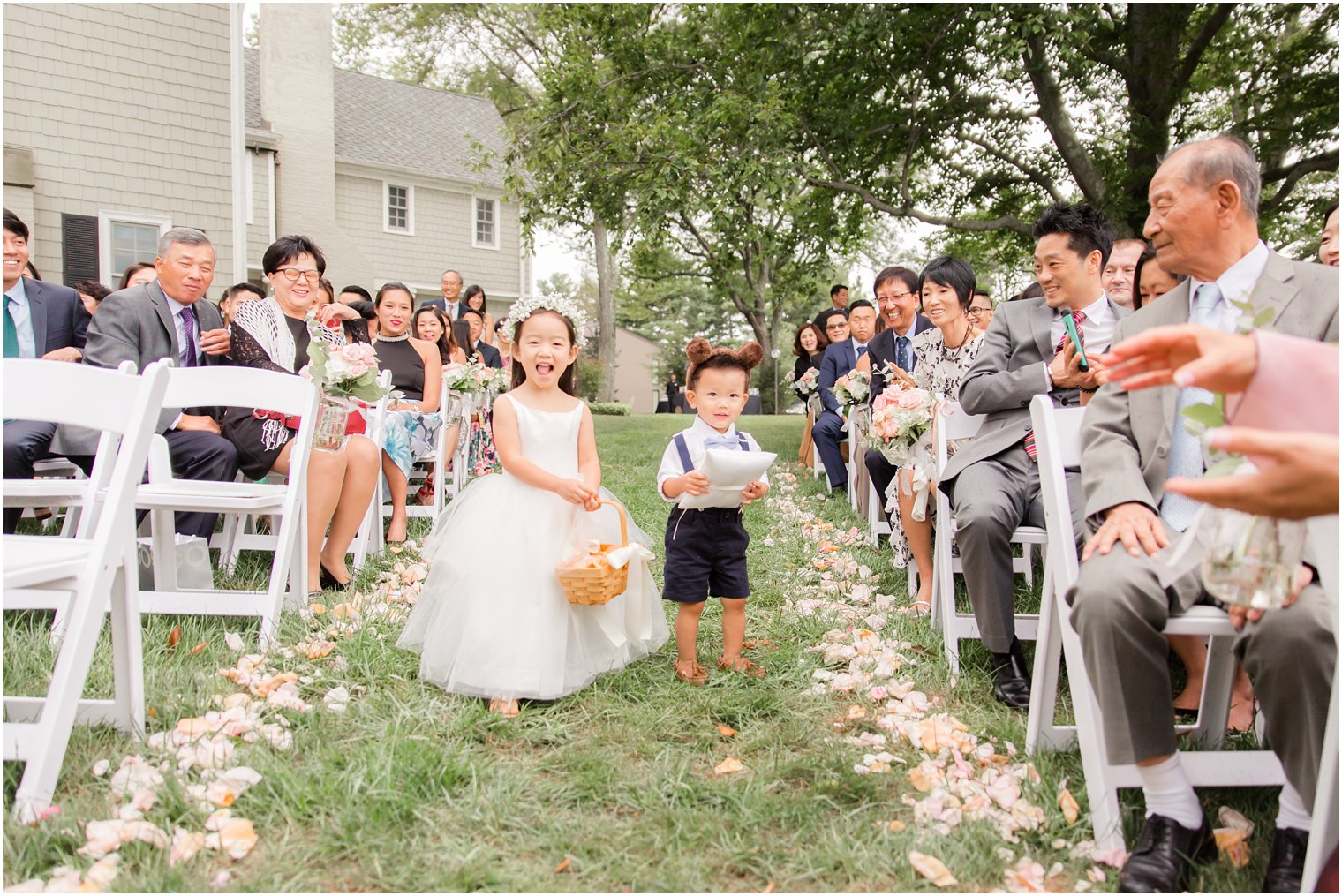 flower girl and ring bearer walk down aisle at Chauncey Hotel during NJ wedding photographed by Idalia Photography