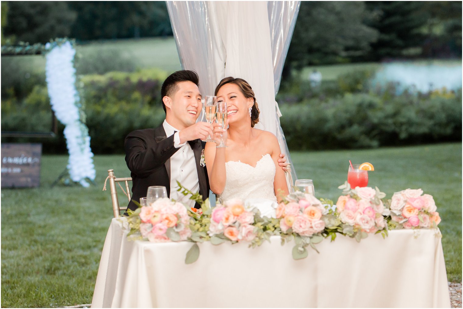 bride and groom clink champagne during reception at Chauncey Hotel photographed by Idalia Photography