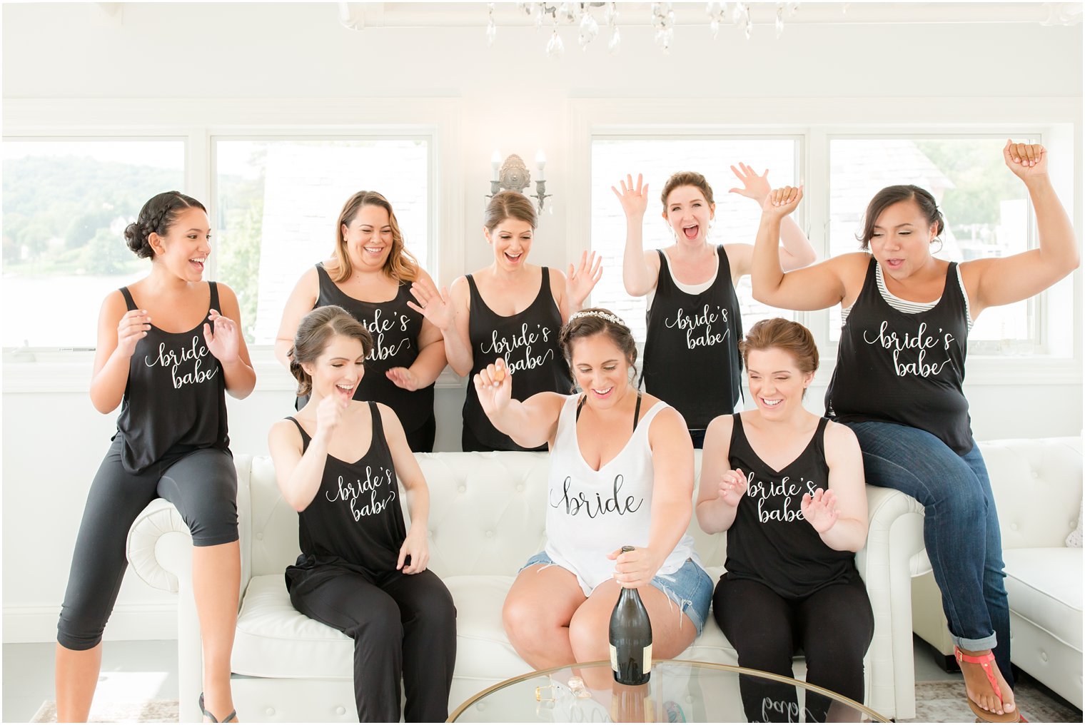 bridal party pops champagne before Lake Mohawk Country Club wedding day photographed by Idalia Photography