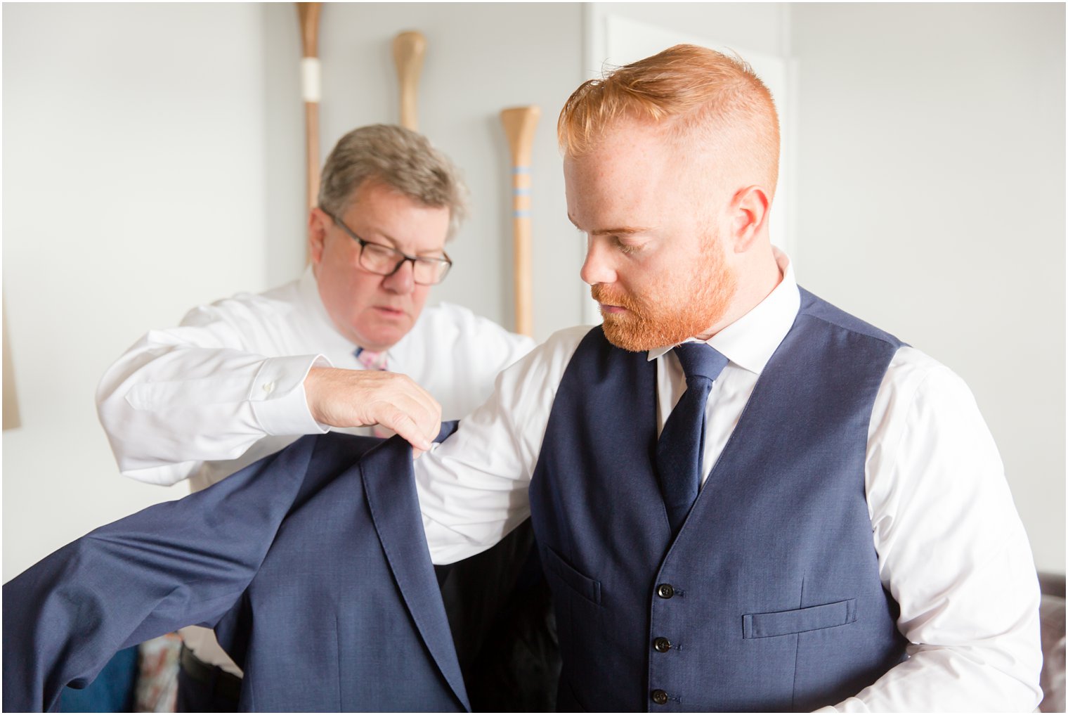 father helps groom with jacket before Lake Mohawk Country Club wedding day