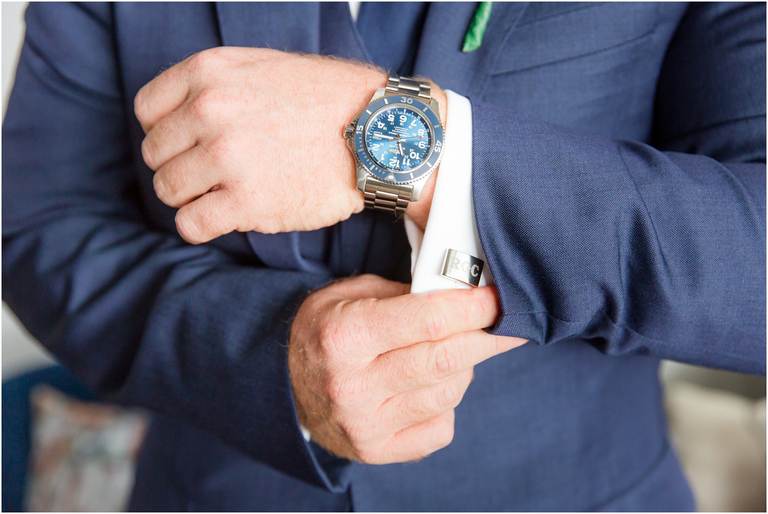 groom adjusts custom cufflinks before wedding photographed by Idalia Photography