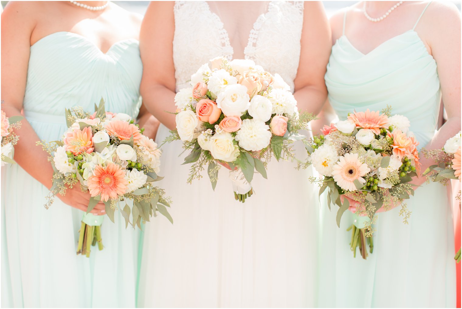 coral daisy and ivory wedding bouquets by Entenmann's Florist