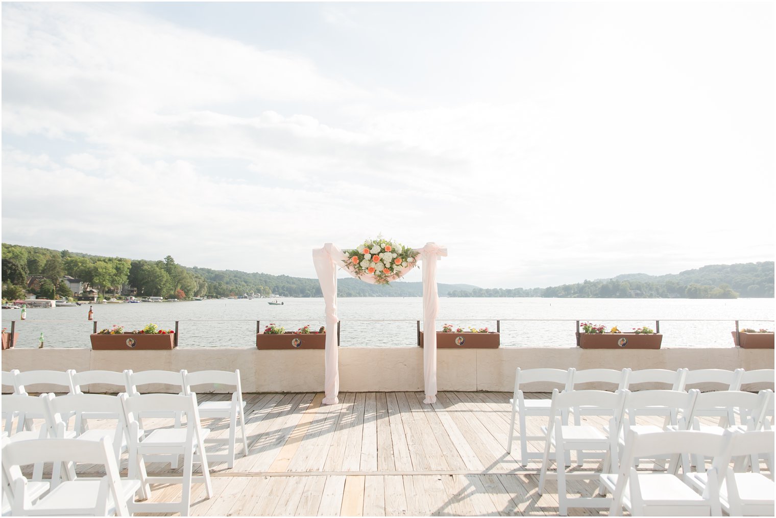 outdoor waterfront wedding ceremony at Lake Mohawk Country Club photographed by Idalia Photography