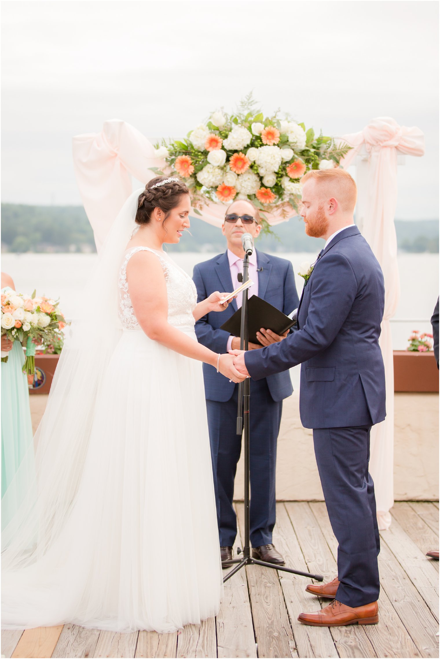bride and groom exchange wedding vows at Lake Mohawk Country Club wedding