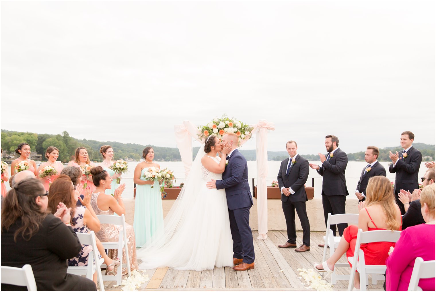 bride and groom kiss at Lake Mohawk Country Club wedding ceremony photographed by Idalia Photography