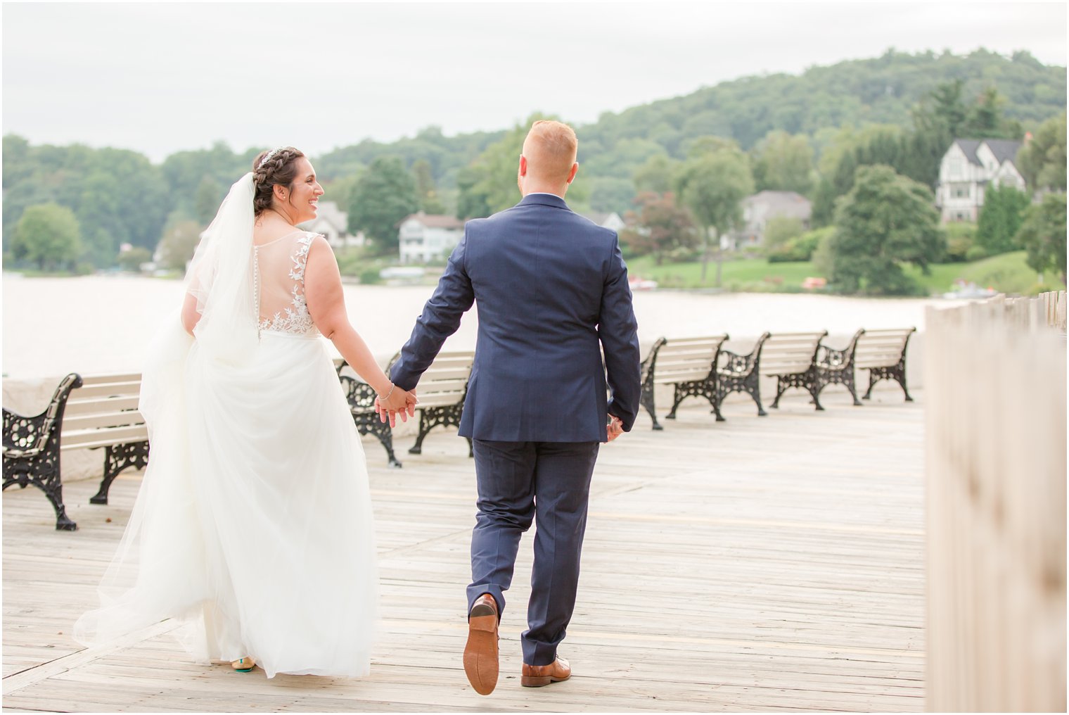 bride and groom walk pier at Lake Mohawk Country Club with Idalia Photography