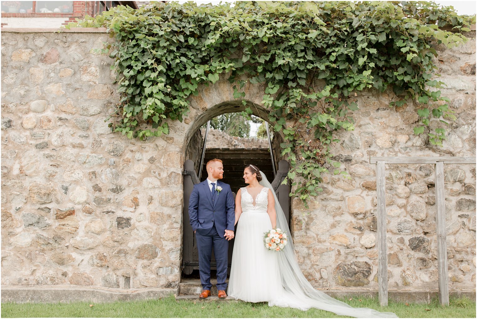 wedding portraits along ivy covered wall at Lake Mohawk Country Club with Idalia Photography