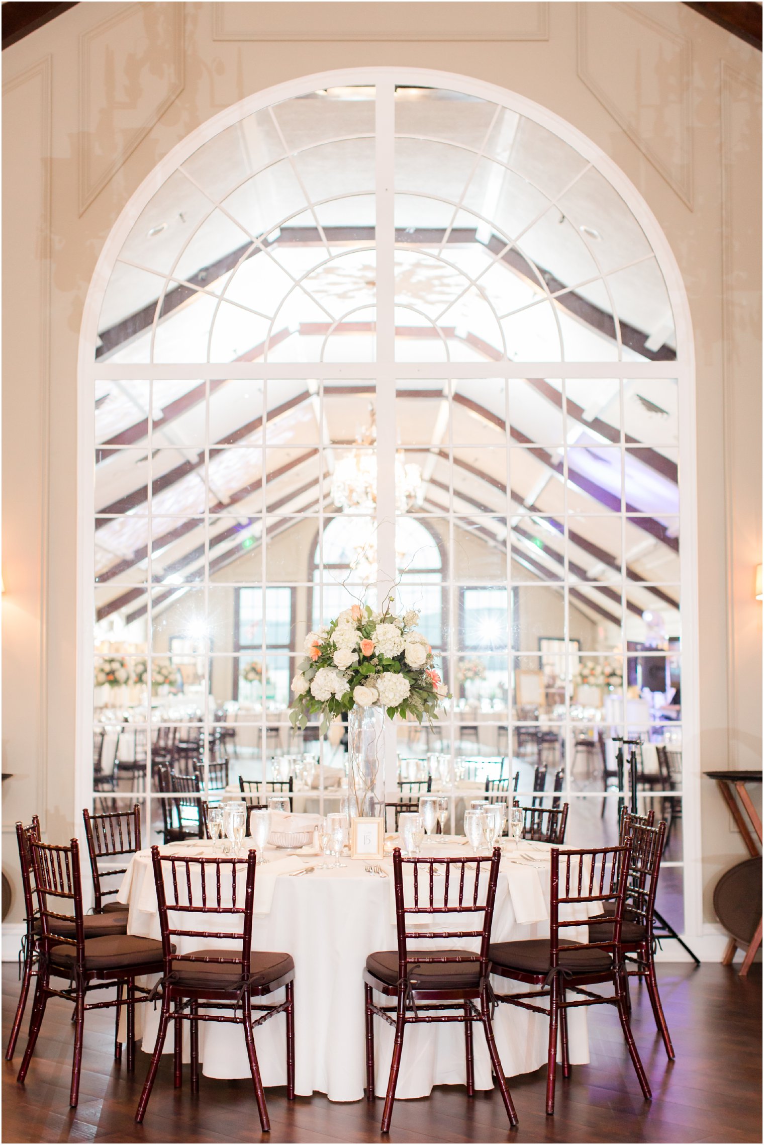 Pink and ivory floral centerpieces by Entenmann's Florist at Lake Mohawk Country Club