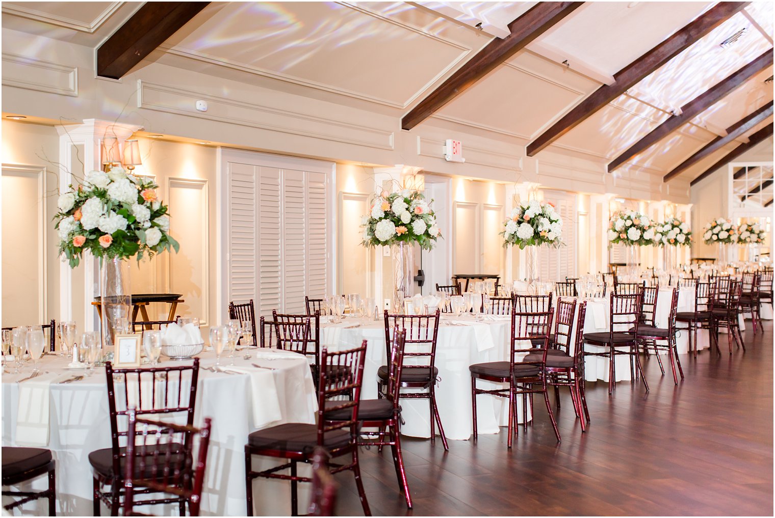 Tall flower centerpieces by Entenmann's Florist at Lake Mohawk Country Club photographed by Idalia Photography