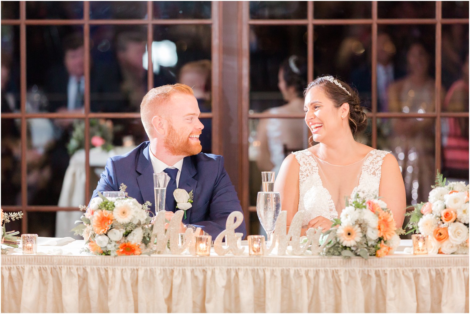 bride and groom enjoy toasts during wedding reception at Lake Mohawk Country Club photographed by Idalia Photography