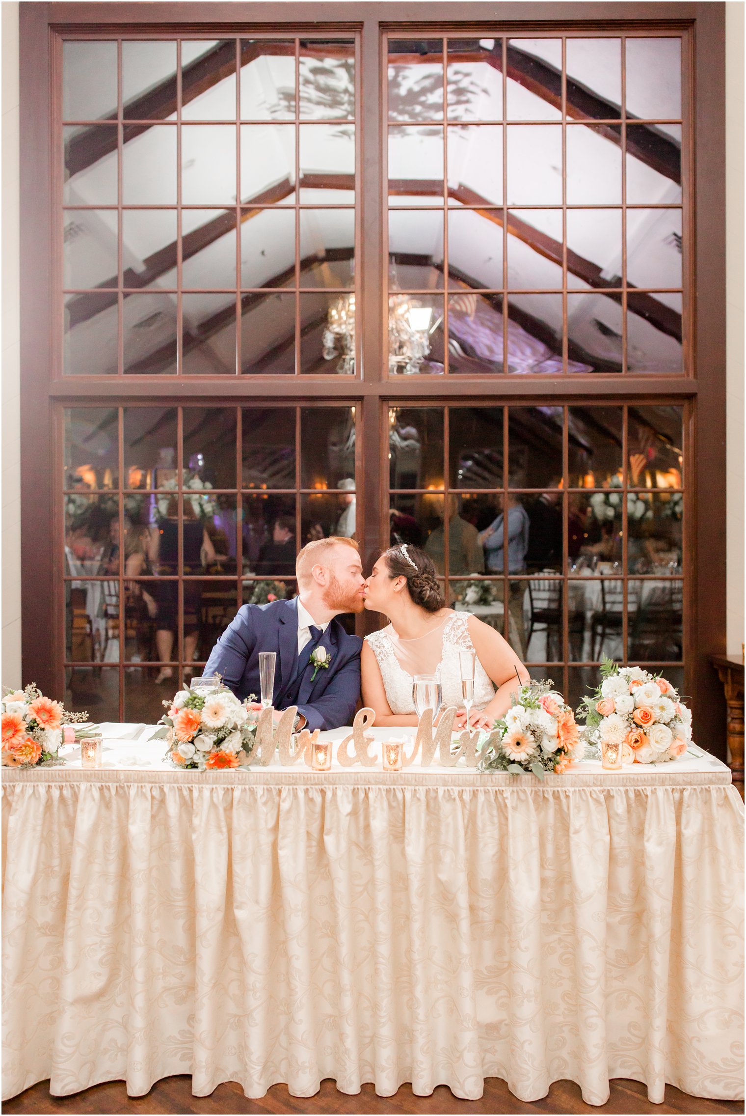 bride and groom kiss during reception at Lake Mohawk Country Club