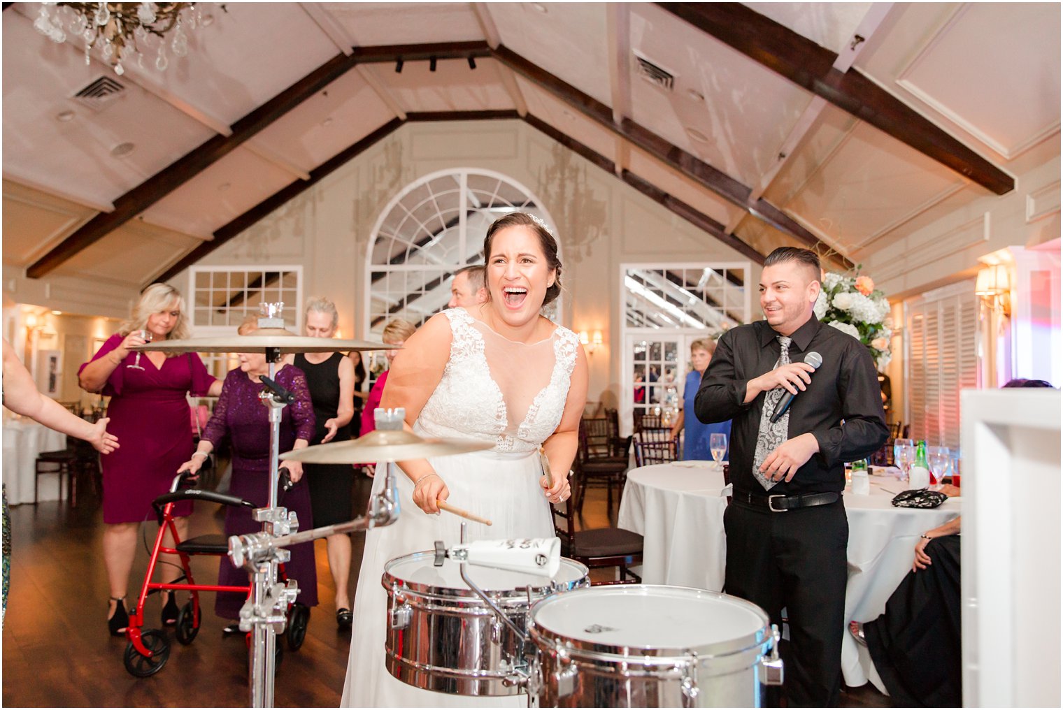bride plays drums with Creative Event Group during reception at Lake Mohawk Country Club