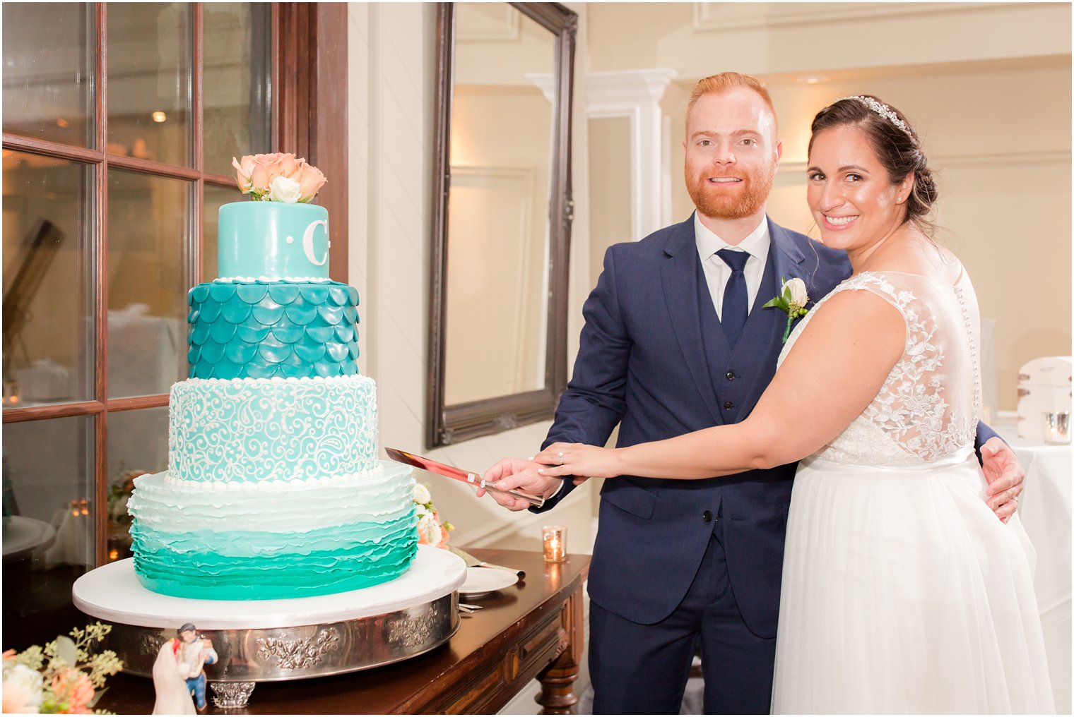 bride and groom cut teal wedding cake by Carlo's Bakery at Lake Mohawk Country Club wedding reception