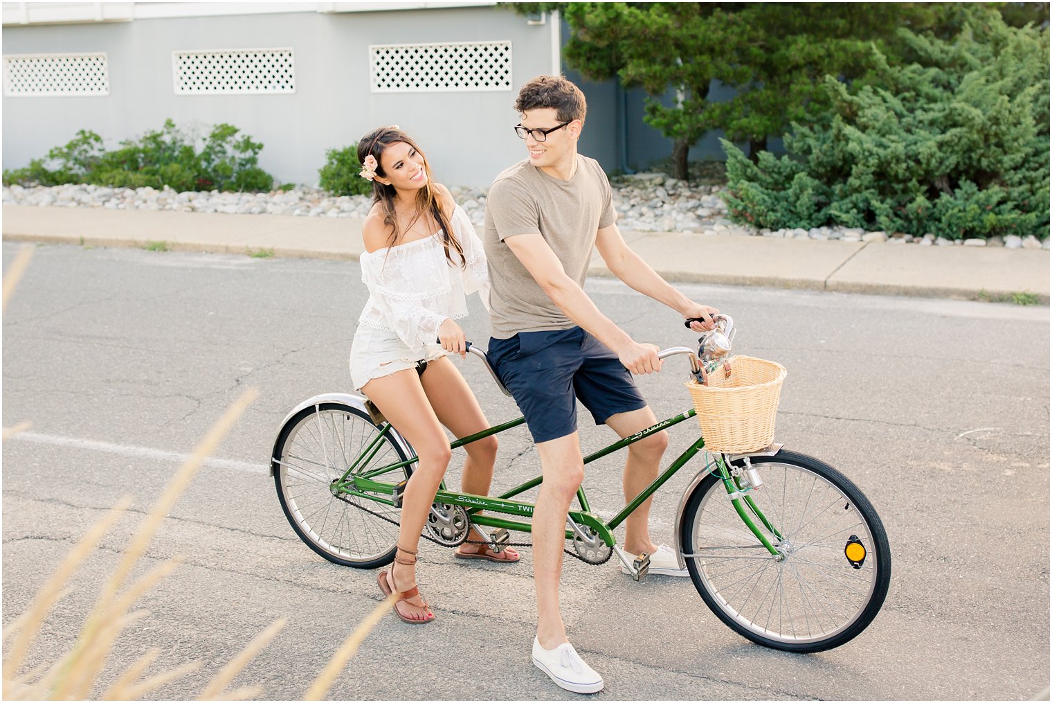 couple poses on bike during Long Beach Island engagement session with Idalia Photography