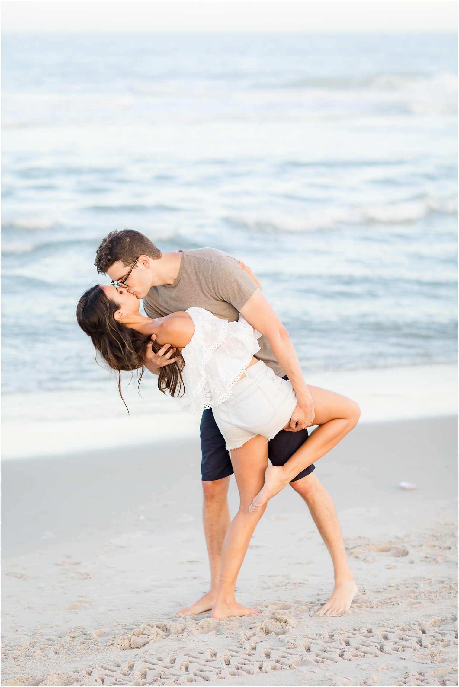 groom kisses bride during Long Beach Island engagement session