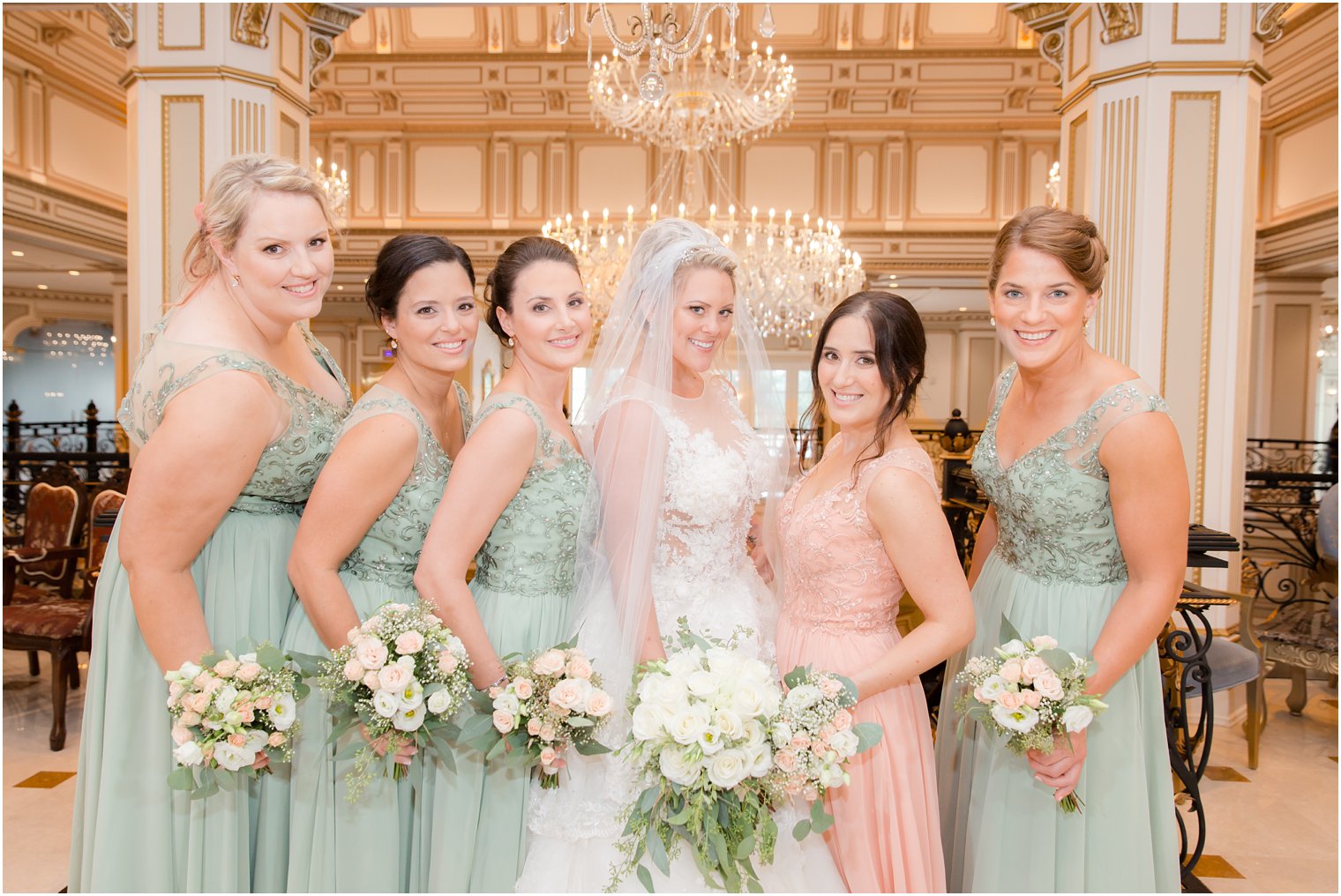 bride and bridesmaids wearing Morilee gowns pose in Legacy Castle with Park Floral wedding bouquets 