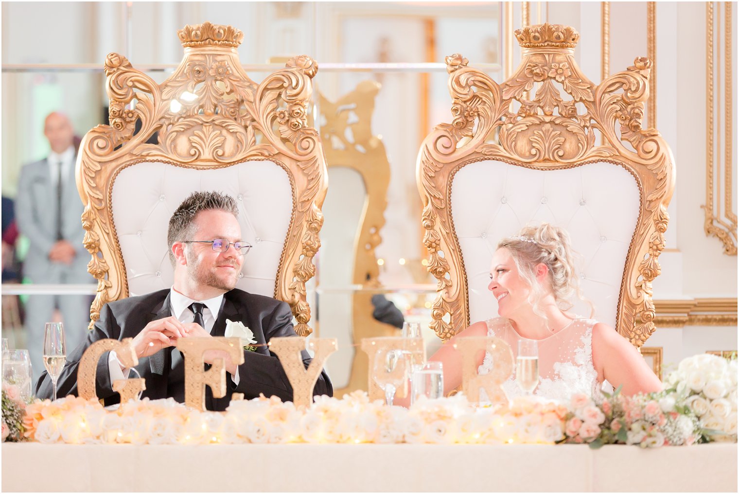 bride and groom in gold highback chairs at Legacy Castle