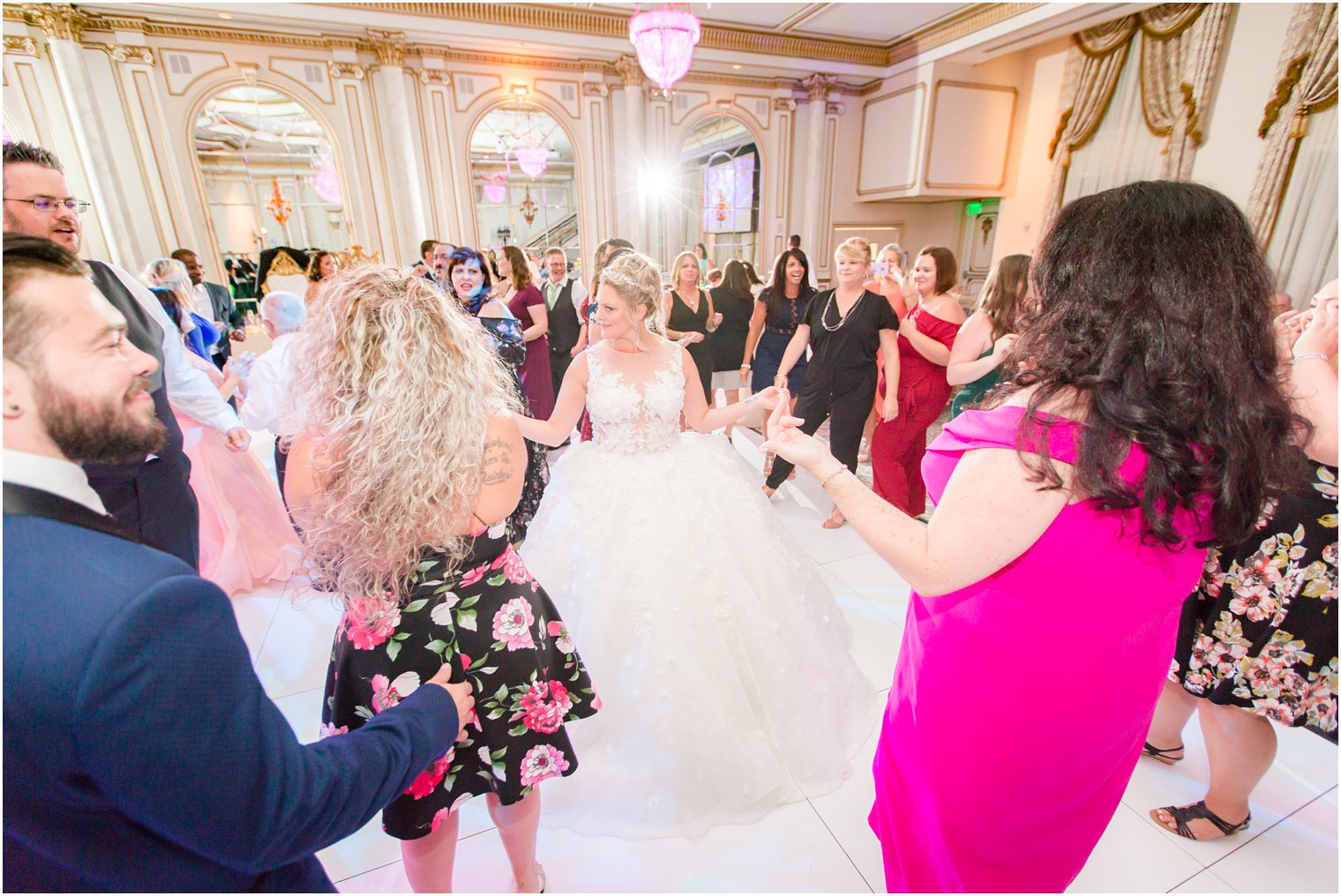 bride dances with guests during reception at Legacy Castle by Idalia Photography