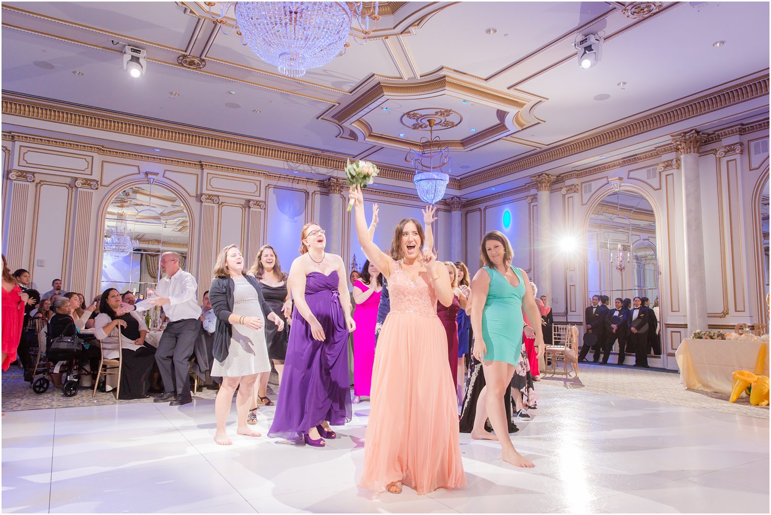 bridesmaid catches bouquet at Legacy Castle reception