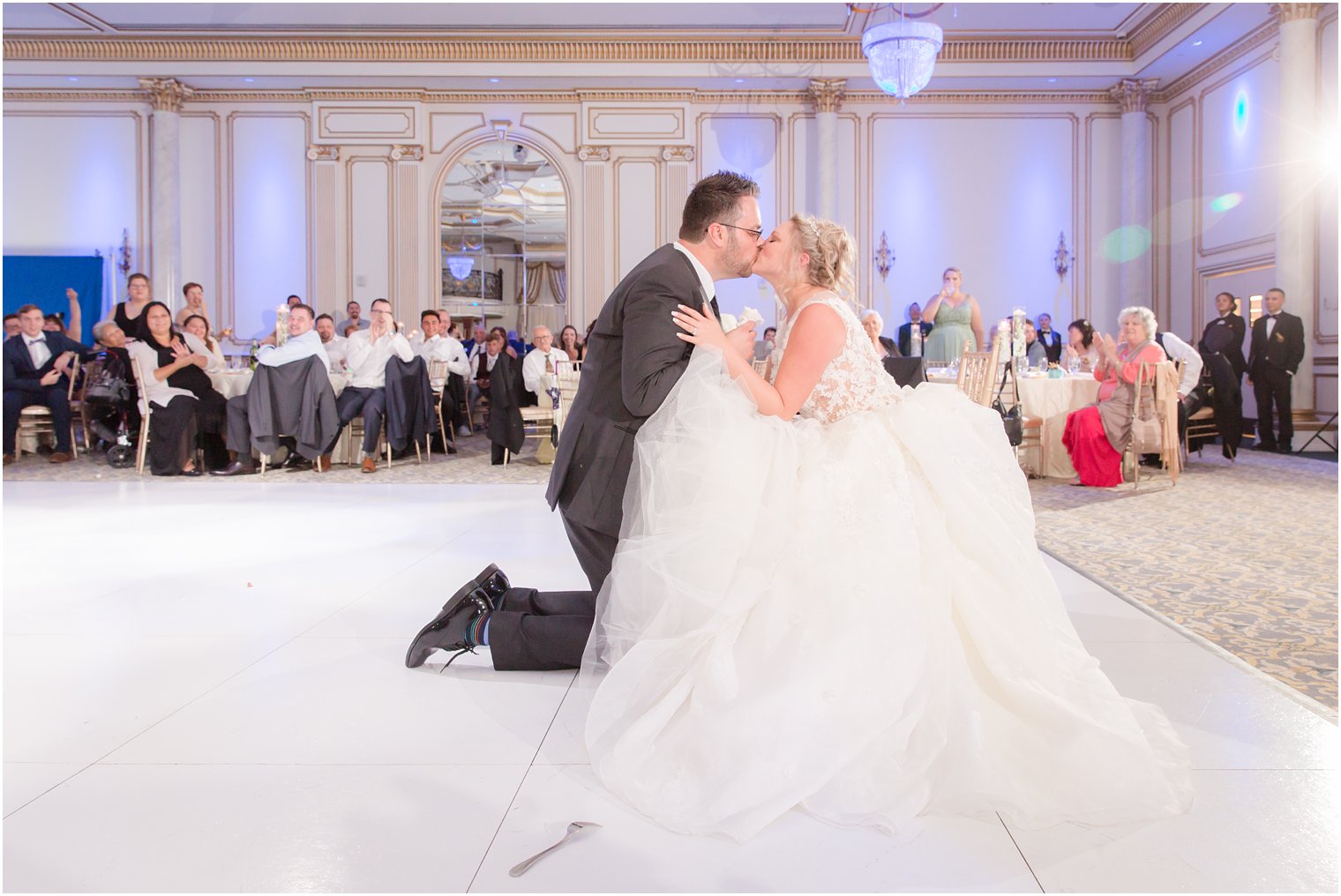 groom gets garter during reception at Legacy Castle in North Jersey