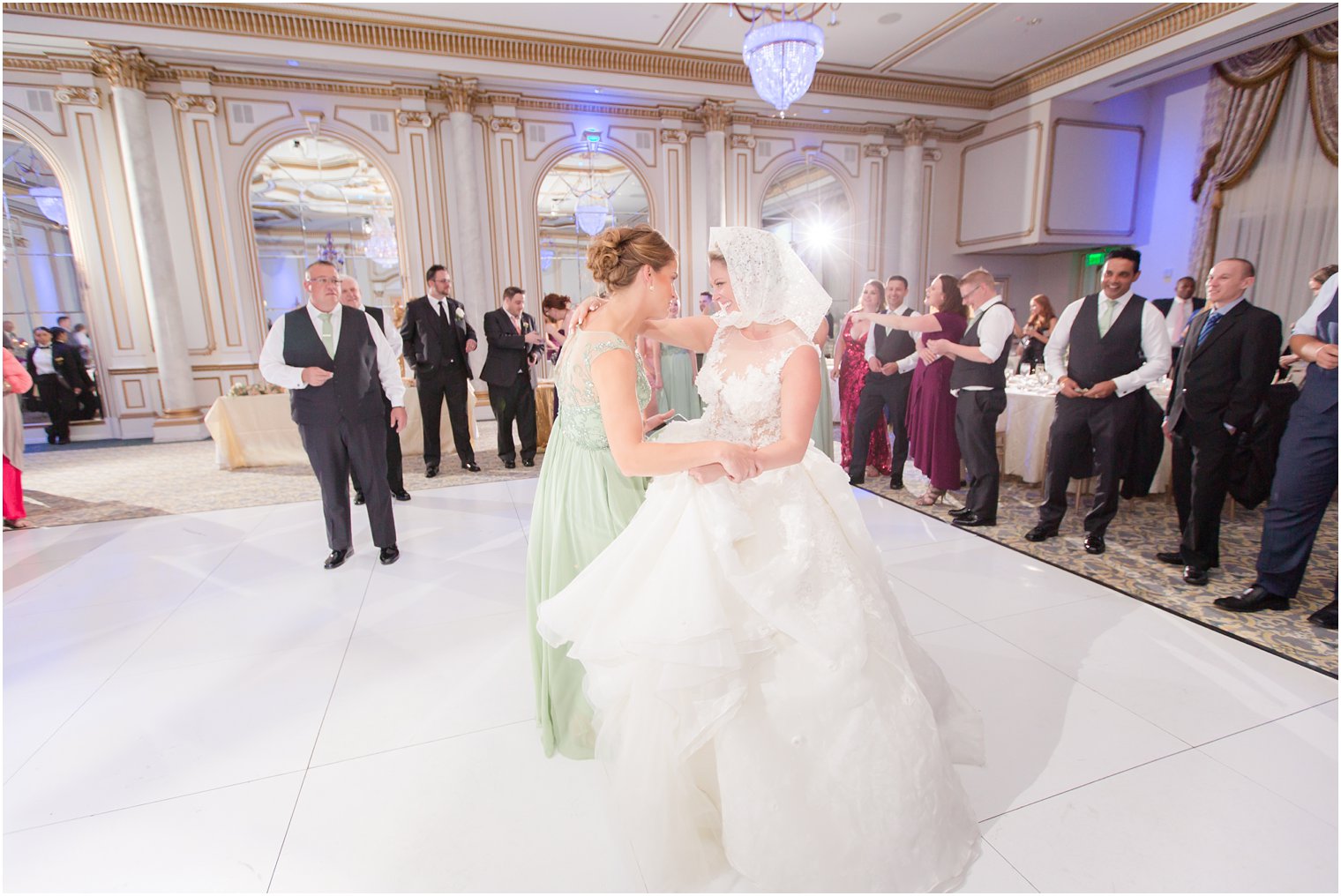 bride and bridesmaid have fun at Legacy Castle wedding reception 