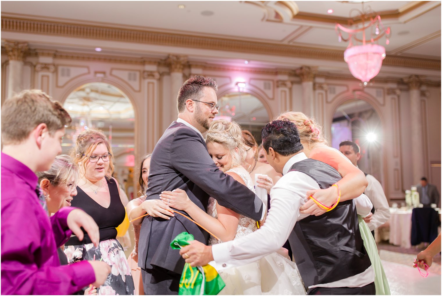 hugging during wedding reception at Legacy Castle photographed by Idalia Photography