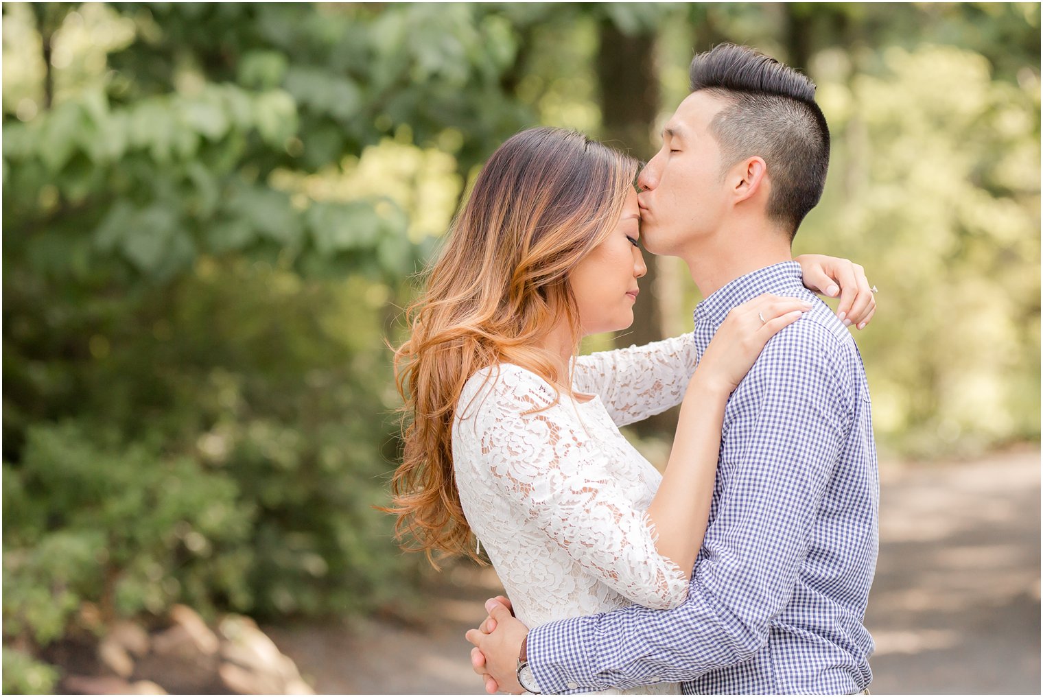 groom kisses bride tenderly during engagement session at Sayen House and Gardens 