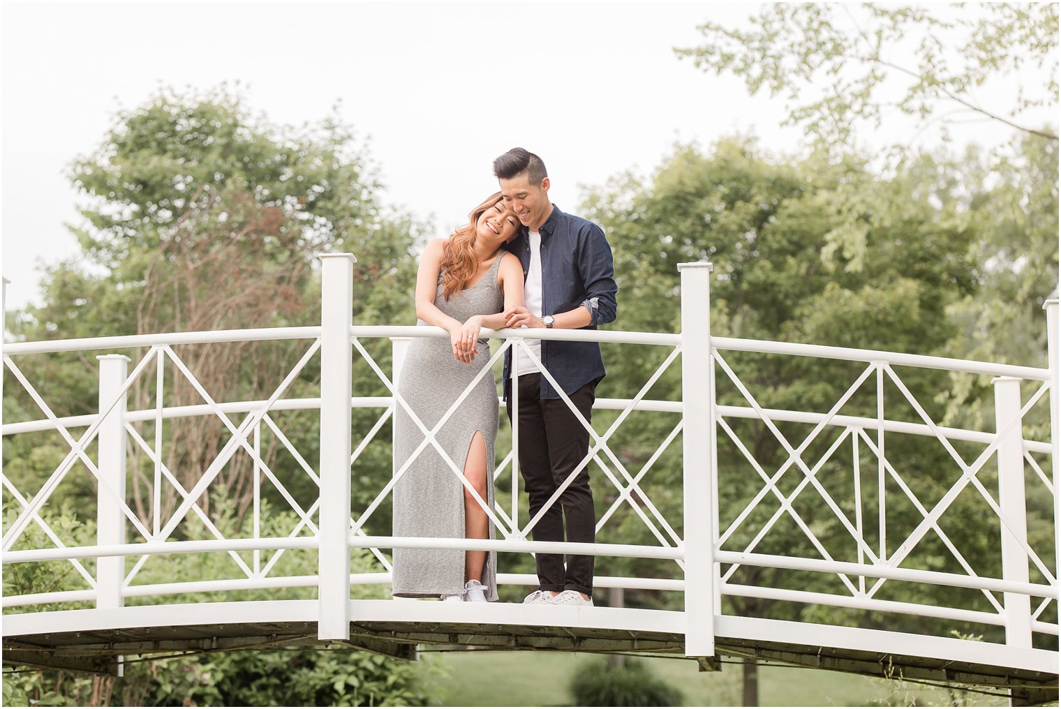 bride and groom pose casually on bridge at Sayen House and Gardens 