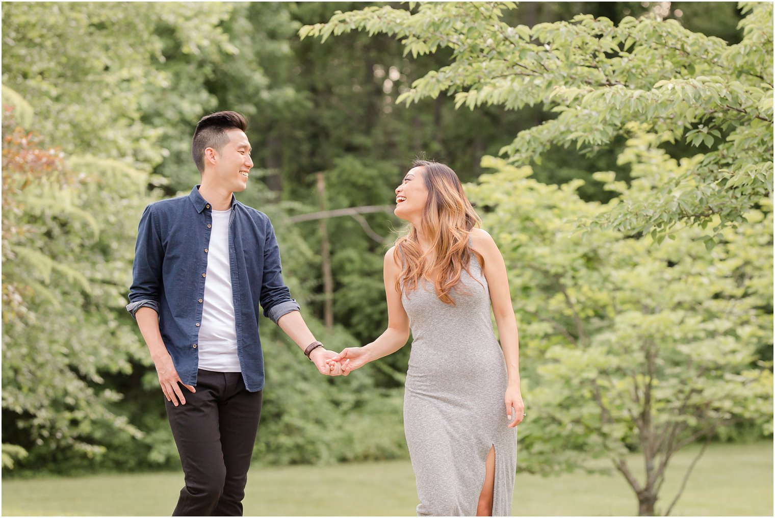couple walks with Idalia Photography at engagement session at Sayen House and Gardens 