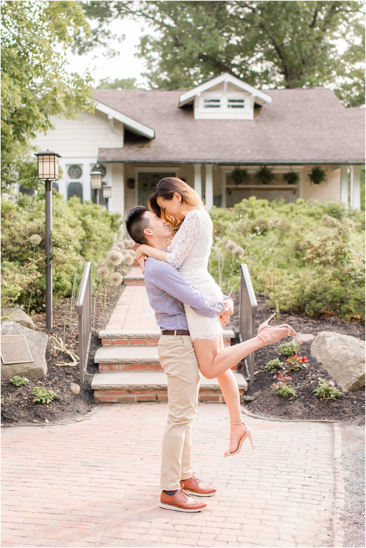 groom lifts bride during engagement session at Sayen House and Gardens 