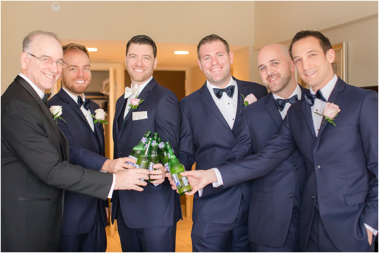 groom and groomsmen toasting
